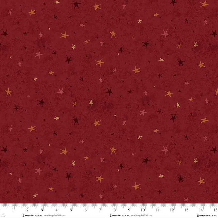 Seeing Stars Basic Red fabric featuring scattered gold, pink and burgundy stars on a textured deep red background.