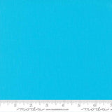 Bright turquoise blue quilting cotton fabric in the Capri colour, featuring a smooth, even solid finish with no printed pattern or additional colours.