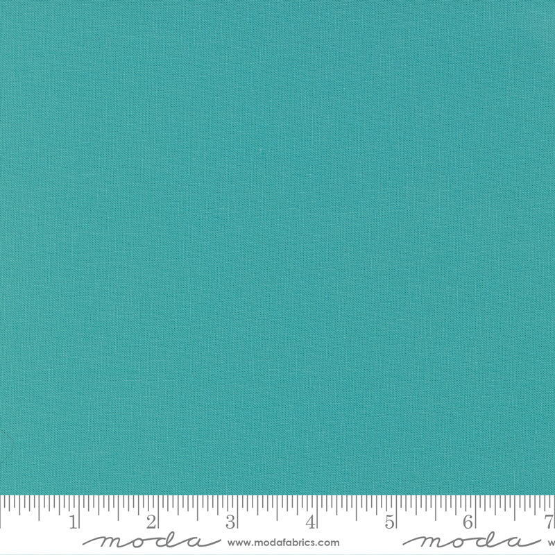 Caribbean Bella Solid from Moda Fabrics is a vibrant, tropical blue-green solid cotton with a rich, refreshing tone.