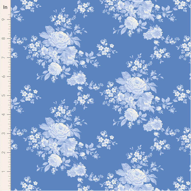 Blue floral fabric featuring trailing roses, petite blossoms and delicate leafy sprigs in cream and layered blue tones on a soft blue background.
