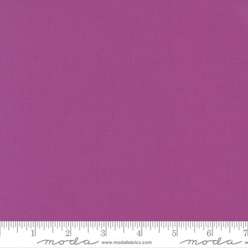 Rich purple quilting cotton fabric in the Cyclamen colour, featuring a smooth, even solid finish with no printed pattern or additional colours.
