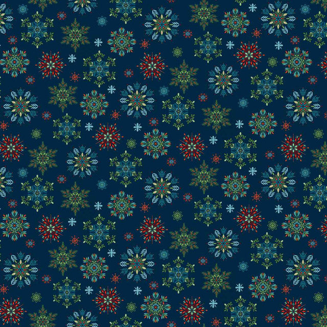 Blue Christmas fabric featuring intricately detailed snowflakes in cream, icy blue, teal and soft green, scattered across a deep blue background with tiny dots resembling falling snow.