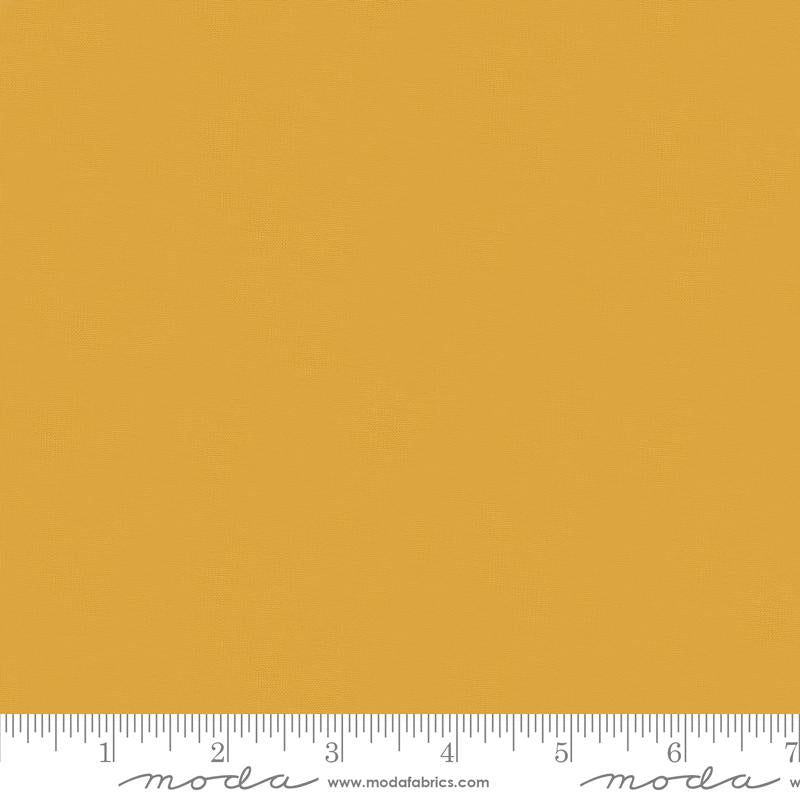 Mustard yellow quilting cotton fabric in the Dijon colour, featuring a smooth, even solid finish with no printed pattern or additional colours.