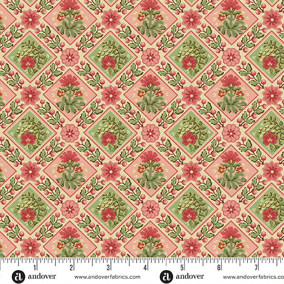 Pink and cream Christmas quilting cotton fabric featuring red and green floral motifs inside diamond shapes, bordered by holly leaves, red berries and flowers.
