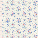 Cream quilting cotton fabric featuring bouquets of pink roses with blue and green leaves, surrounded by small blue floral sprigs and dotted circles.