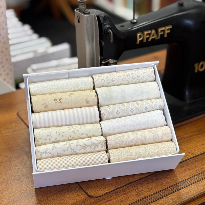 Frontier Fabircs Clotted Cream Bundle containing a box of 12 low volume fabrics. cut into fat quarters