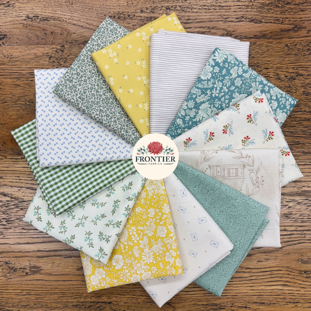 A circular arrangement of multiple fat quarters in various patterns including florals, stripes, gingham, and dots in yellow, green, blue, white, and beige, displayed on a rustic wooden background with a central 'Frontier Fabrics' logo.