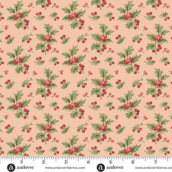 Strawberry cream Christmas quilting cotton fabric featuring green holly branches and clusters of red berries scattered across a pale pink background with smaller holly sprigs.