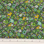Small dense floral on cotton lawn with leafy, lime and aqua on a black background with golden yellow scattered throughout