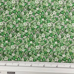 Japanese lawn fabric with a dense small-scale floral print in fresh green, sage and cream, featuring tiny flowers and leafy botanical details.