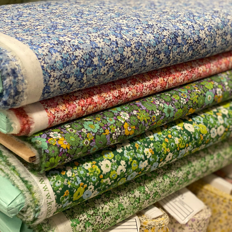 Five bolts of fabric with delicate florals in green, pink and blue. Japanese lawn Koma from Nutex. 