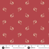Cranberry red Christmas quilting cotton fabric featuring small cream jingle bells scattered across a deep red background with curled hanging loops and decorative stripes.