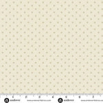 Small beige mini dots on a warm cream linen-coloured background, shown with the Andover Fabrics selvage ruler. Laundry Basket Quilts. Frontier Fabrics.