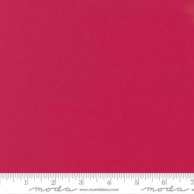 Deep pinkish-red quilting cotton fabric in the Lipstick colour, featuring a smooth, even solid finish with no printed pattern or additional colours.