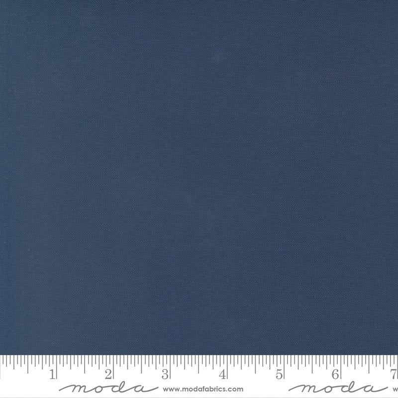Rich deep blue quilting cotton fabric in the Nautical Blue colour, featuring a smooth, even solid finish with no printed pattern or additional colours.