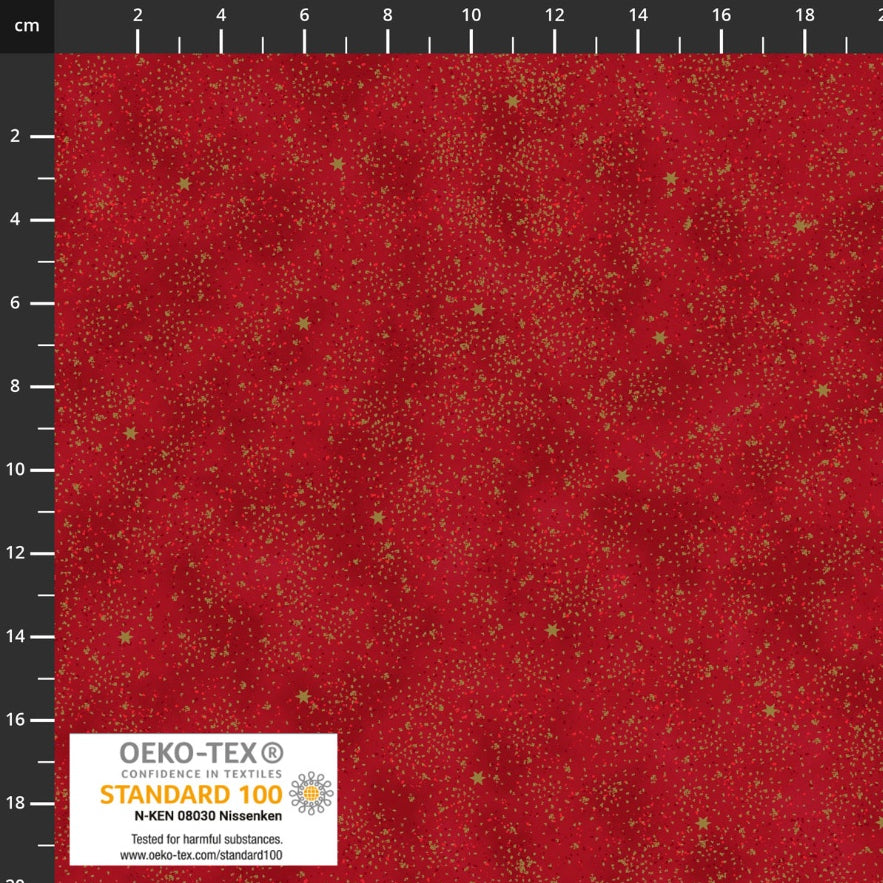 Red Christmas fabric with fine gold speckles and scattered small gold stars creating a subtle festive stardust effect.
