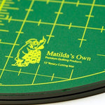 Green rotary cutting mat with yellow grid lines and 'Matilda's Own' branding.