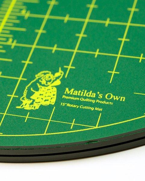 Green rotary cutting mat with yellow grid lines and 'Matilda's Own' branding.