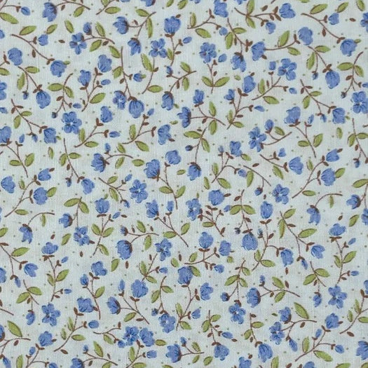 A delicate small-scale floral print from Sevenberry, featuring tiny soft blue blossoms and buds scattered across a pale blue background. Fine brown trailing stems weave lightly through the design, with fresh green leaves adding a gentle natural contrast.

This sweet cottage-style print has a fresh, airy feel and is ideal for quilting, patchwork, craft sewing, linings, borders, small accessories, and soft vintage-inspired projects.