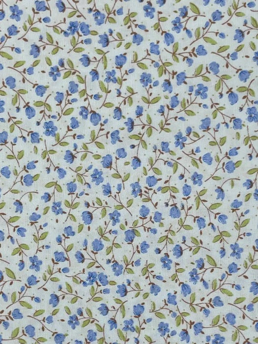 A delicate small-scale floral print from Sevenberry, featuring tiny soft blue blossoms and buds scattered across a pale blue background. Fine brown trailing stems weave lightly through the design, with fresh green leaves adding a gentle natural contrast.

This sweet cottage-style print has a fresh, airy feel and is ideal for quilting, patchwork, craft sewing, linings, borders, small accessories, and soft vintage-inspired projects.