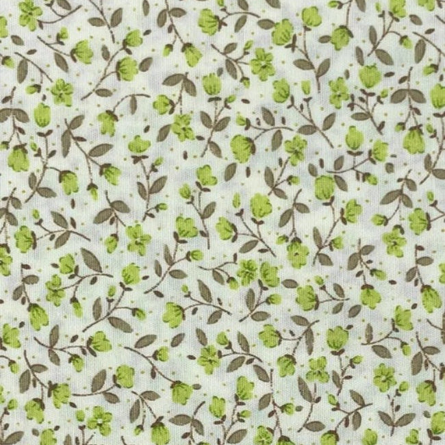 Delicate Green Floral is a small-scale floral vine print on a soft cream background. Fine taupe-brown trailing stems weave gently across the fabric, scattered with tiny fresh green blossoms, buds, and muted leafy details. The design has a light, natural and slightly vintage feel, making it a lovely choice for quilting, patchwork, craft projects, linings, and soft cottage-style sewing.