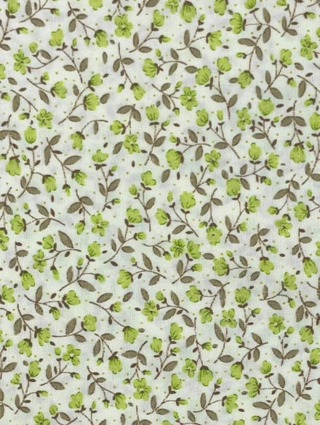 Delicate Green Floral is a small-scale floral vine print on a soft cream background. Fine taupe-brown trailing stems weave gently across the fabric, scattered with tiny fresh green blossoms, buds, and muted leafy details. The design has a light, natural and slightly vintage feel, making it a lovely choice for quilting, patchwork, craft projects, linings, and soft cottage-style sewing.