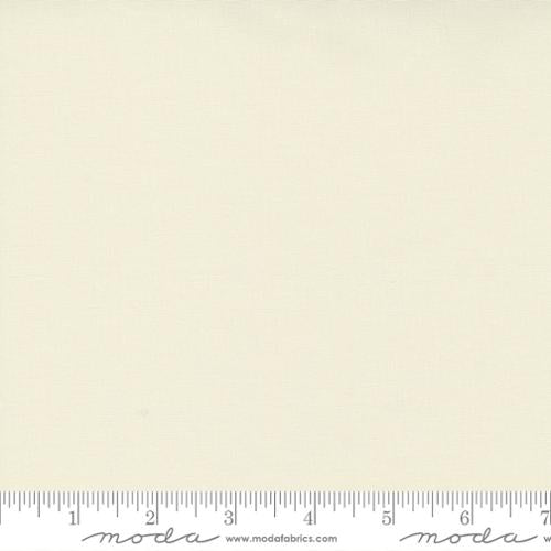 Creamy off-white quilting cotton fabric in the Silky Snow colour, featuring a smooth solid finish with a subtle sheen and no printed pattern.