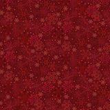 Red fabric featuring a detailed snowflake print with delicate white and cream snowflakes scattered across a rich red background. The winter-inspired pattern creates a festive holiday design with a mix of large and small snowflake details for a classic seasonal look.