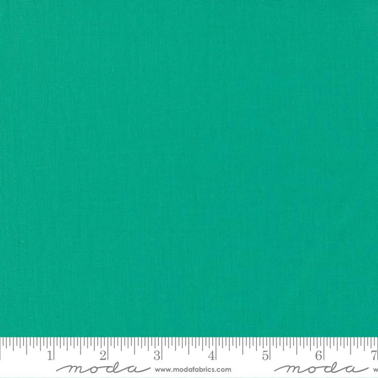Fresh spearmint green quilting cotton fabric in the Spearmint colour, featuring a smooth, even solid finish with no printed pattern or additional colours.