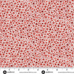 A lively all-over scatter of small stars, dots, and twinkling starburst motifs in shades of red on a pale cream background. M225QR