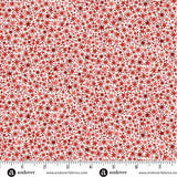 A lively all-over scatter of small stars, dots, and twinkling starburst motifs in shades of red on a pale cream background. M225QR