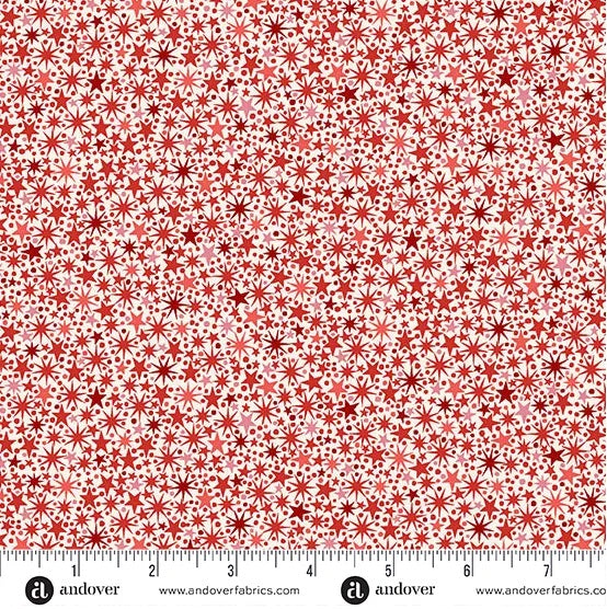 A lively all-over scatter of small stars, dots, and twinkling starburst motifs in shades of red on a pale cream background. M225QR